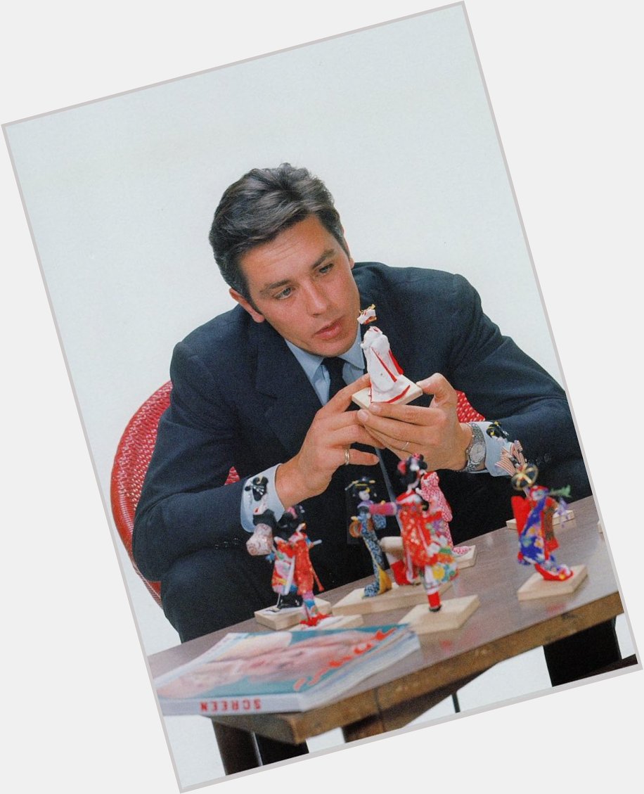 Happy birthday Alain Delon (pictured in Japan, playing with traditional dolls. On the table     magazine) 