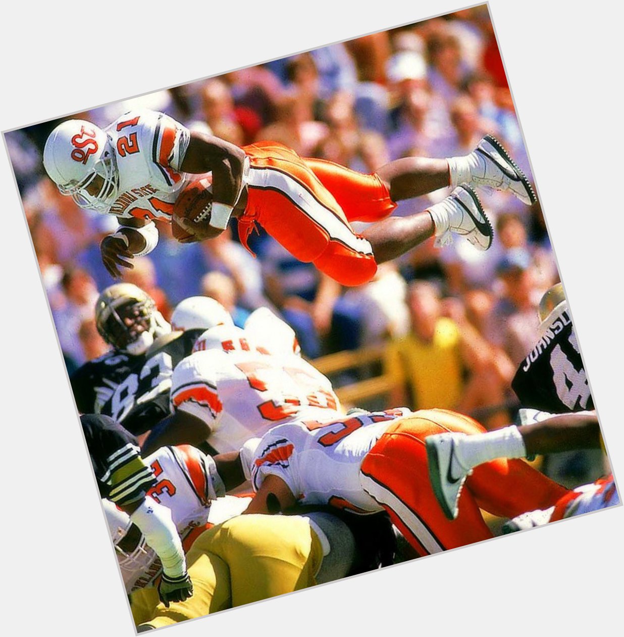 Barry Sanders leaps over the defense in the classic OSU jerseys Happy Birthday Barry! 