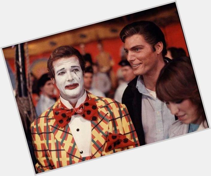 Happy 87th Birthday Roger Moore!!! Here in Clown costume being visited by Christopher Reeve on the set of Octopussy 