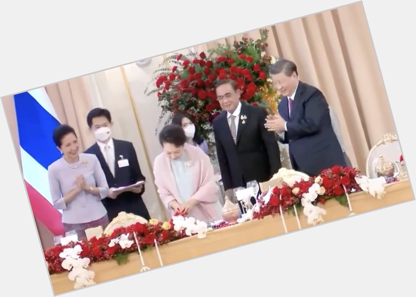 He continues clapping while Peng Liyuan\s birthday cake is cut.  Happy 60! 